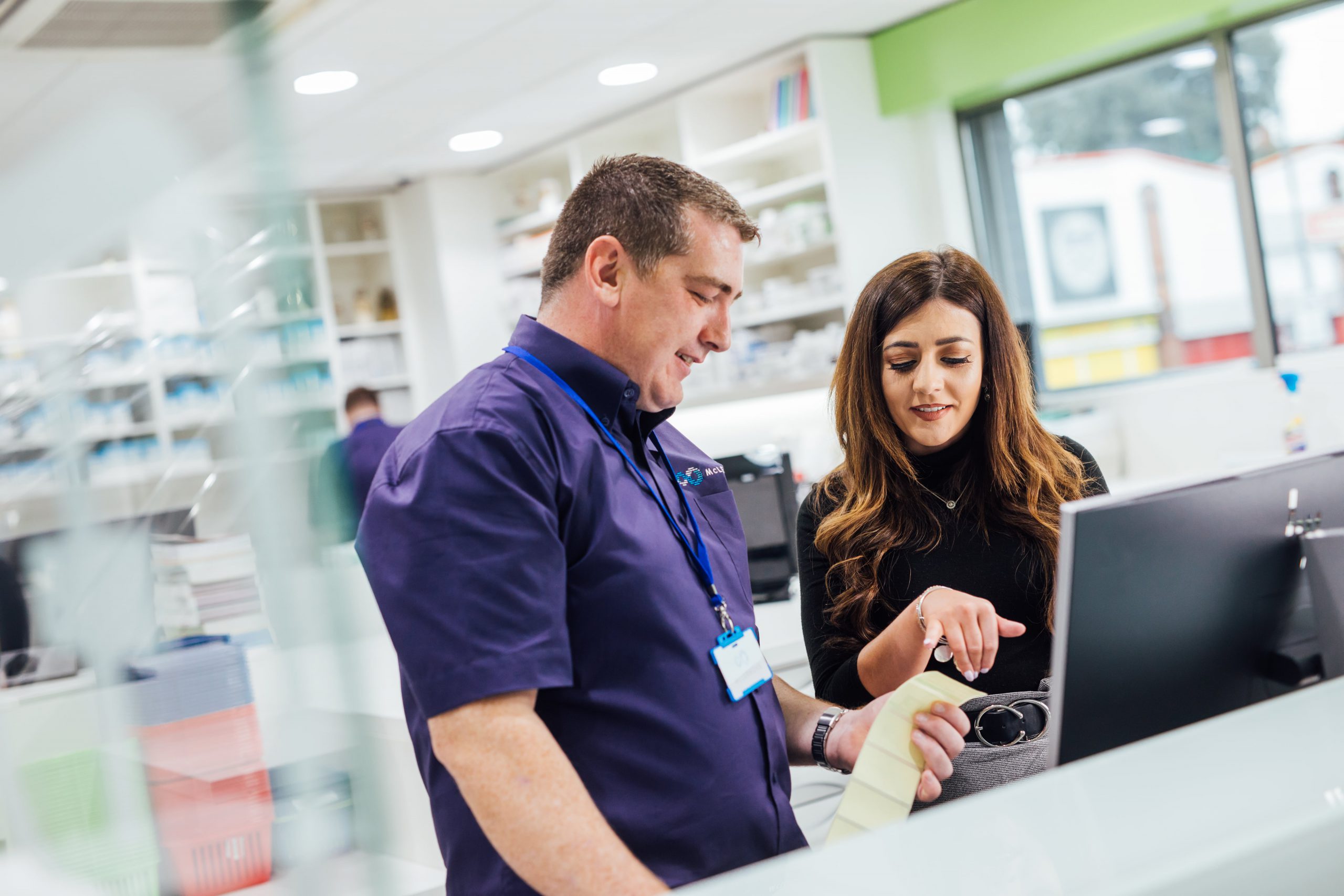 A McLernons trainer with pharmacy staff